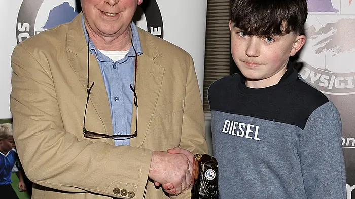 WCSSL Chairman Declan Deasy presents the U13 Boys Premier Player of the Year to Eoghain Holland (Dunmanway Town).