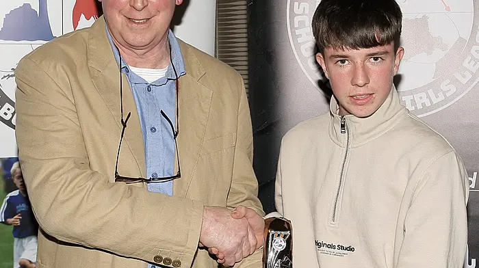 WCSSL Chairman Declan Deasy presents the U14 Premier League Boys Player of the Year to Gearoid O'Keeffe (Castlelack).