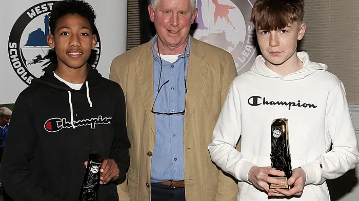 U12 Boys Premier Player of the Year joint winners, Kingsley Crosby Osagie (Skibbereen) and Danny Carroll (Dunmanway) with WCSSL Chairman Declan Deasy.