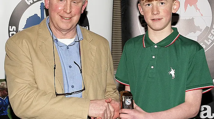 WCSSL Chairman Declan Deasy presents the West Cork Academy U13 Player of the Year 2023-24 to Michael Ryan (Lyre Rovers).