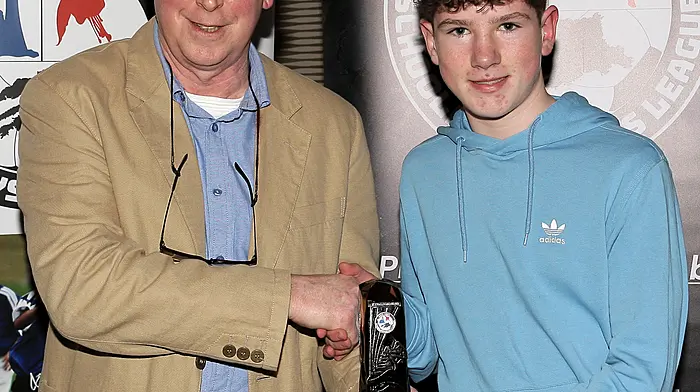 U14 Championship Boys Player of the Year Michael O'Donovan (Ardfield FC) with WCSL Chairman Declan Deasy.