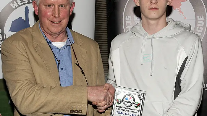 WCSSL Chairman Declan Deasy presents the Overall Player of the Year to Alex Bramoule, Dunmanway Town.