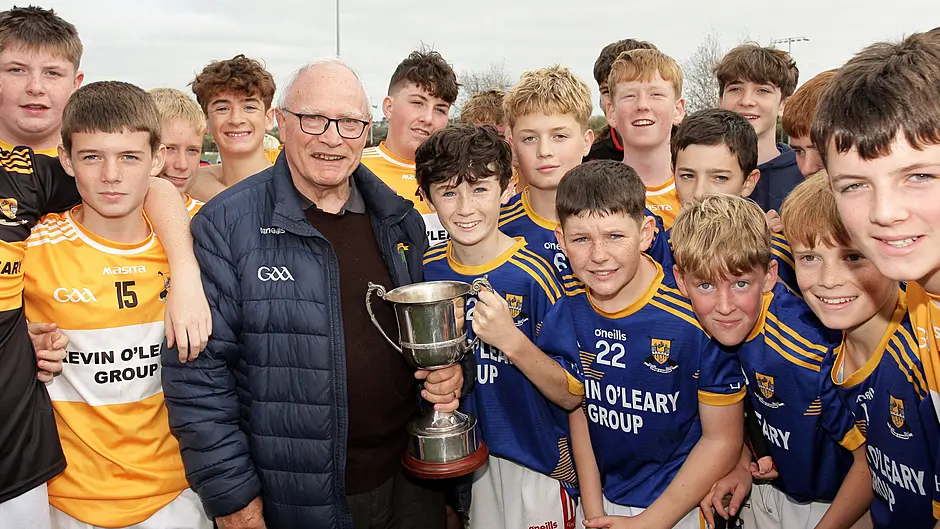 Tom Lyons, brother of the late Raymond Lyons, presents The Raymond Lyons Perpetual Memorial Cup to Jack O'Donoghue, captain of the Hamilton High School Blues team.(Photo: Paddy Feen)