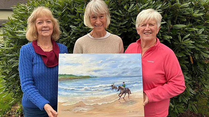 Bandon Art Group members Ann Barry, Tish Canniffe and Clare Holland with Ann’s painting of Inchydoney Beach. The group will be holding its annual coffee morning on Friday November 7th at the Perfect Cup.