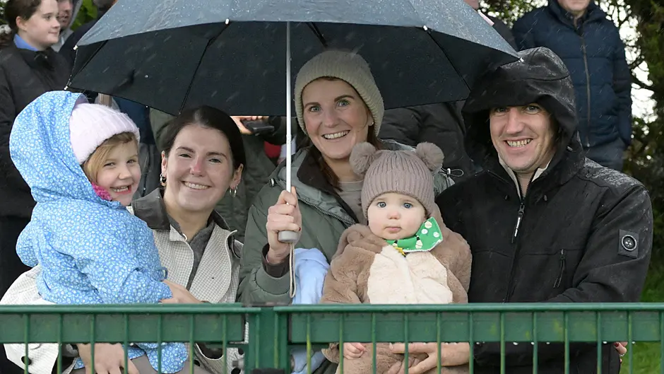 Kilmacabea fans Aisling Murray, Aoife Whooley, Laura Murray, Shane Murray and Peter Murray smiling in the rain as their team beat Carraig Na bhFear in the McCarthy Insurance junior A football championship quarter-final in Newcestown.   (Photo: Martin Walsh)