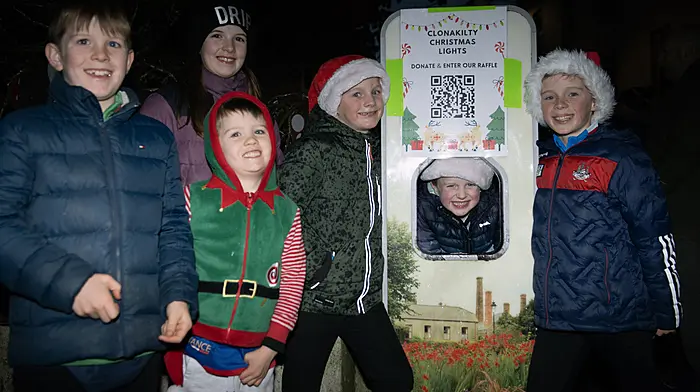 Rosscarbery's Michael Flavin looking through the water refill station at Astna Square with his friends at the parade in Clonakilty.  (Photo: Martin Walsh)