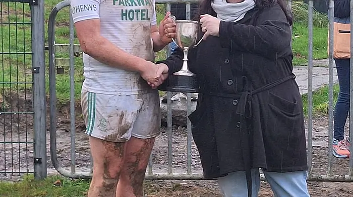 Doheny U21 captain Gavin Farr receiving the cup from Martina Burns of the Carbery Board after the Doheny U21 hurlers won the Carbery U21 C hurling championship last weekend when they defeated Randal Óg on a scoreline of 2-12 to 0-5.
