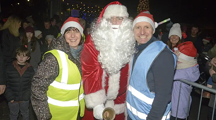 Hillary O’Farrell and Peter Applebe of Bandon Business Association celebrating with Santa at the switching on of the new Christmas lights in Bandon.   (Photo: Denis Boyle)