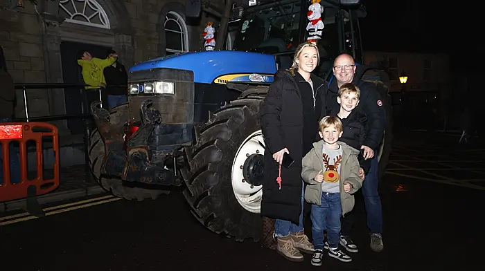 Niall and Stacy O'Regan, with their children Jack and Joshua, posing in front of the  decorated tractor during the annual Christmas tree lighting ceremony in Schull. (Photo: Carlos Benlayo)