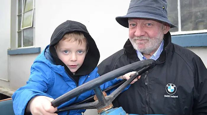 Theo O'Shea and his grandad Denis O'Shea, Drimoleague at the Drinagh Tractor. (Photo: Anne Minihane)