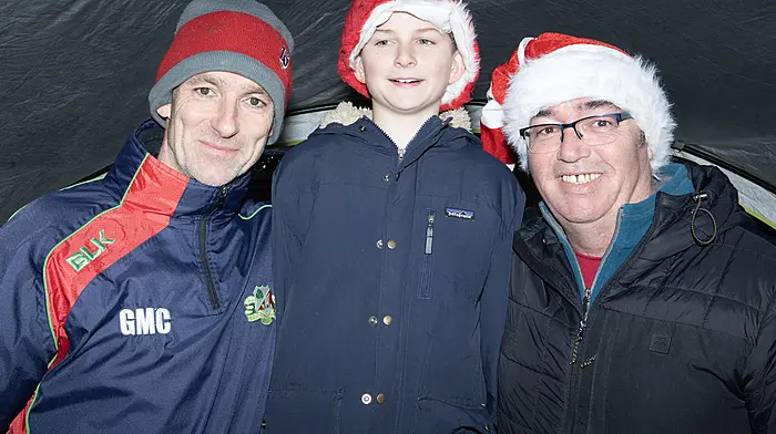 Members of Clonakilty Rugby Club at their Christmas raffle hub in Astna Square (left to right): Garret and Calum McCabe and William Deasy.  Photo: Martin Walsh.