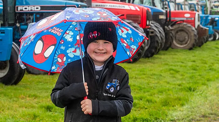 Ballinacarriga, West Cork, Ireland. 29th Mr, 2026. Despite a very wet day in West Cork, there was a good turnout for the Ballinacarriga charity tractor, car and truck run which took place today. The run was held to raise funds for Cancer Connect; Ballinacarriga National School and Randall Óg GAA Club. Staying dry under his Spiderman umbrella was Paddy Deasy from Innishannon. Picture: Andy Gibson.