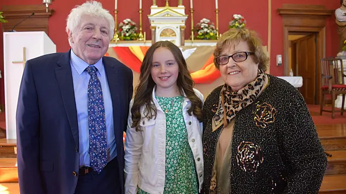 Saoirse Buckley from Castletownshend National School who received her Confirmation at St. Barrahanes Church in Castlehaven pictured with her grandparents Jack and Abina Buckley. Photo; Anne Minihane.