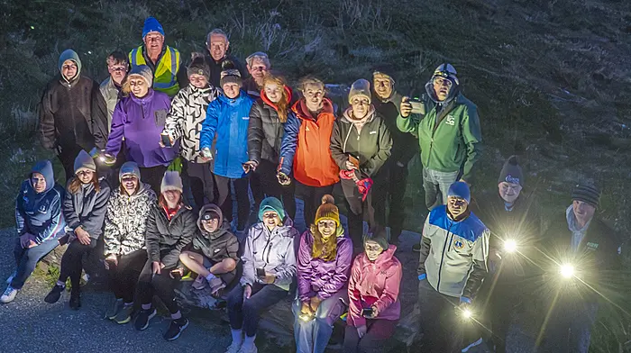 Participants in the Darkness into Light walk in Kilcrohane seen at the top of the Goats Path, which they reached as dawn was breaking last Saturday morning.  (Photo: Donal O'Connell)