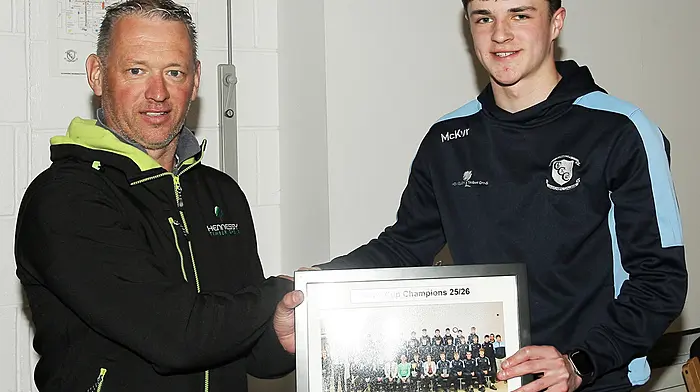 Clonakilty Community College's Seán Whelton presented their team sponsor Aidan Hennessy of Hennessey Timber Group Ltd with a team picture of the history-making winning team at the Simcox Cup medal presentation held in the school. (Photo: Paddy Feen)