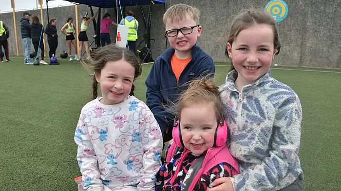 Grace, Adam and Isabel Collins with their cousin Cora Crowley watching the activity at the Body Active Hyrox at O'Donovan Rossa GAA grounds in Skibbereen. Photo; Anne Minihane.