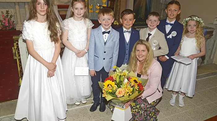 Ahiohill National School pupils with their teacher Miss Ann Marie O'Donovan, who was presented with flowers, on the occasion of the celebration of the pupils’ First Holy Communion.   (Photo: Denis Boyle)