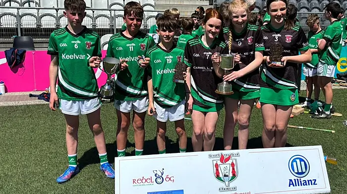 Scoil Eoin captains Tom Murphy and Reuben Cullinane with Andrew Collins, and captain Saoirse Forde with Hannah O'Donovan and Emily May Keane when Scoil Eoin recorded an historic double in Siath na Scol camogie and hurling finals at Pairc Ui Chaoimh.