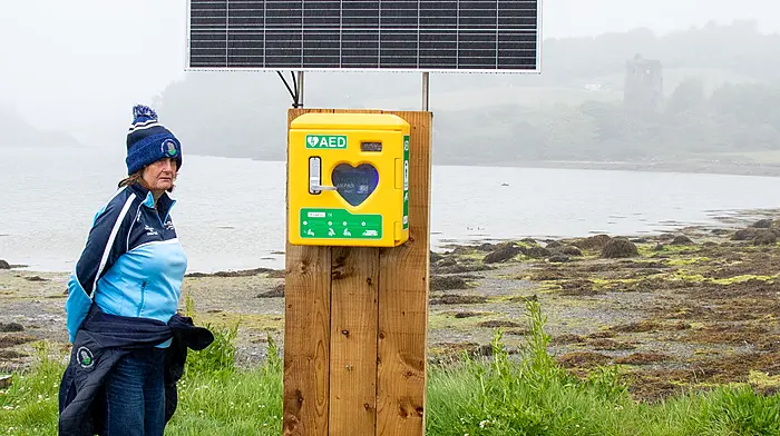 Mary Hallihane inspecting the new defibrillator at Raheen, Union Hall. The device was paid for by local fundraising efforts and boasts a solar panel to ensure the battery is kept fully charged for use when required.    (Photo: Andrew Harris)
