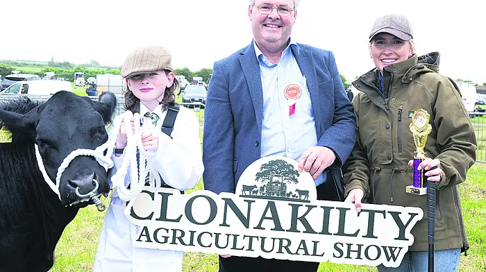 Peadar Williamson from Durrus with Belgian Blue Cross ‘Betty’ a class winner at the Clonakilty Agricultural Show with show judge Sean Sherman, Rathdowney and Katie Calnan, Leap.  (Photo: Martin Walsh)