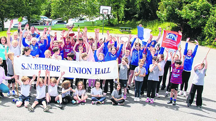 Pupils and staff of Scoil Naomh Bhríde gathered to celebrate the schools’ victory in the Sciath Na Scol, retaining the title from last year.   (Photo: Andrew Harris)
