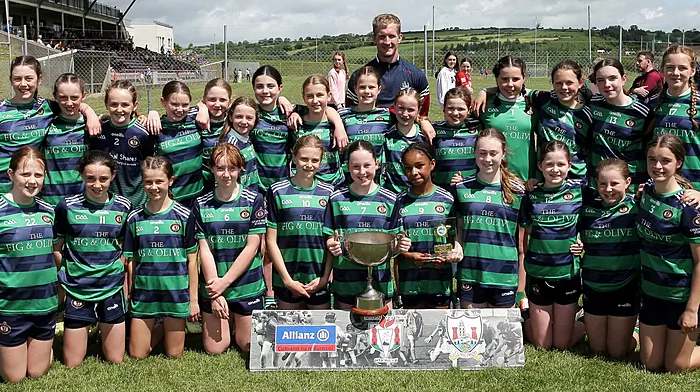 Gaelscoil Mhichíl Uí Choileáin, winners of Roinn 2, with Cork footballer Ruairí Deane. (Photo: Paddy Feen)