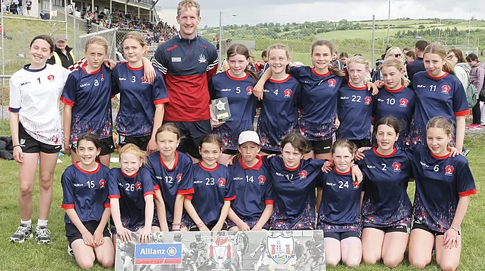 Bunscoil Fachtna Rosscarbery, runners up in Roinn 3 Girls, with Cork footballer Ruairí Deane. (Photo: Paddy Feen)