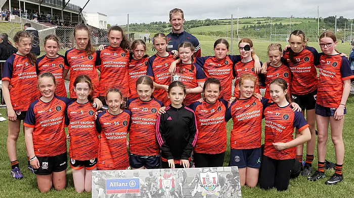 Kealkill NS, runners up in Roinn 1 Girls, with Cork footballer Ruairí Deane. (Photo: Paddy Feen)