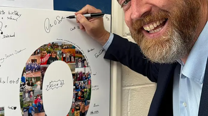 Celebrating 40 years of St Multose National School, Cork South West Deputy and Minister of State Christopher O’Sullivan signs a memory board during the school’s 40th celebration on Saturday.
