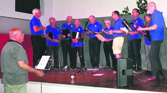The Clonakilty Men's Shed choir on stage at the Ballinascarthy Hall last Sunday where they sang to an engaged audience. From left: Hugh O'Callaghan, John Loughnane, John Dennis, Billy Brennan, Pat O'Neill, John McNulty, Eugene Claffey, Michael White, Kevin O'Brien and Billy Dunphy with conductor Martin Valley.