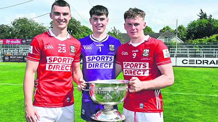 Barryroe's Riley O'Donovan (left) and Conrad Murphy with Kilmeen's Rory Twohig (centre) and the Tom Markham Cup after Cork's victory over Tyrone in the Electric Ireland All-Ireland minor football final in St Conleth's Park, Newbridge.  (Photo: Martin Walsh)