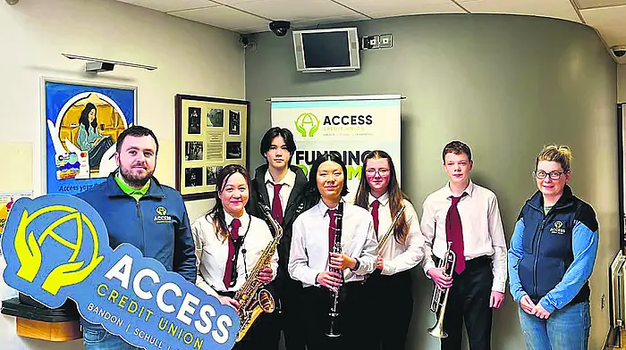Members of the Bandon Concert Band alongside Eoghan Kelleher and Kate Murray when the band played last Saturday at the Access Credit Union premises after they had played in the Riverview Shopping Centre.