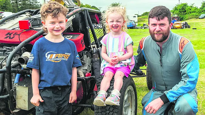 Castletown Kinneigh, West Cork, Ireland. 4th Jul, 2026. Cork Autograss Club hosted Round 2 of the All Ireland Autograss series this weekend. Racers from all over the country, including the North, descended on Castletown Kinneigh for 2 days of racing. Pictured in the pits are Kodie & Eva-Lynn McCarthy-O'Mahony with their racer dad Cian O'Mahony from Clonakilty. Picture: Andy Gibson.
