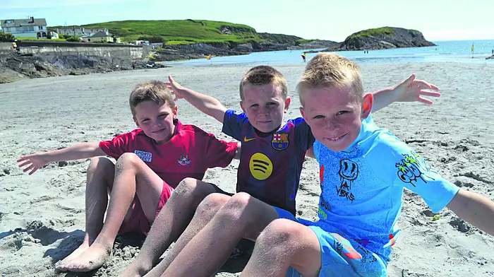 Luke Crowley with Frankie and Paddy Collins from Skibbereen enjoying the wonderful sunshine on Tragumna beach last weekend. Photo; Anne Minihane.