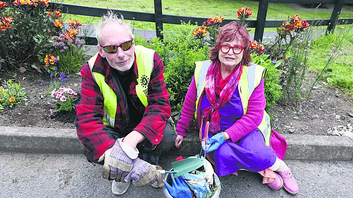 Schull Tidy Towns volunteers Maura Allen and Eamonn Smith help brighten the village by planting flowers and tidying public areas as part of ongoing efforts to keep Schull looking its best. Photo by Carlos Benlayo