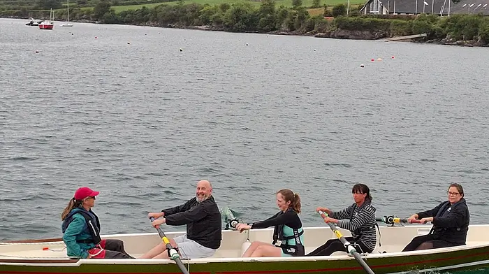 Pictured are existing club members with new rowers who joined through the \