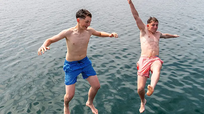 Bantry, West Cork, Ireland. 10th Jul, 2026. Bantry basked in 26°C temperatures today as Met Éireann has classed the hot weather as a heatwave. Cooling off in Bantry Bay were Donnacha Cronin Murphy and Eoin McCarthy from Bantry. Picture: Andy Gibson