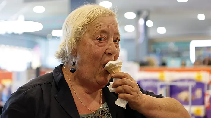 Rita O'Donovan enjoying an ice cream while making the most of the warm, sunny weather in Schull. Photo by Carlos Benlayo