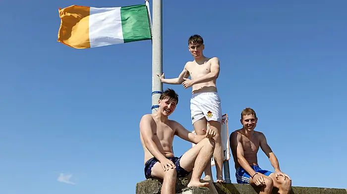 Johnny Ellis, Jack O'Shea and Freddie O'Shea make the most of the sunshine at Schull Harbour pier, taking the plunge to cool off as souring temperatures draw  crowds to the water. Photo by Carlos Benlayo