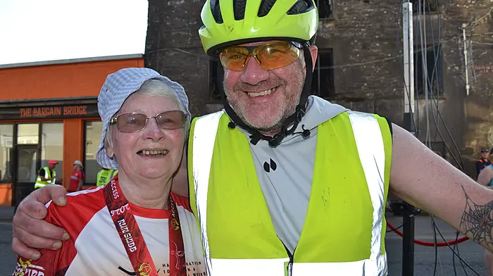 Skibbereen lady Siobhan O'Mahony with her cyclist bodyguard Alan Swanton was delighted to complete the Run Skibb 5k on Saturday evening and bring a huge smile to volunteers and supporters faces. Photo; Anne Minihane.