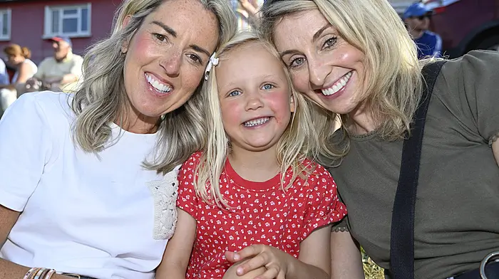 All smiles at the opening of the Courtmacsherry Harbour Festival were locals (left to right): Carla Horrigan with Robyn and Grace O'Donovan. Photo: Martin Walsh.