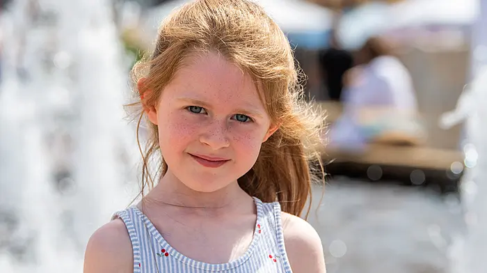 Bantry, West Cork, Ireland. 24th Jul, 2026. Bantry Market was thronged with people today making the most of the 22°C weather. Taking a rest at Bantry fountain was 5 year old Zoe Quinlan from Courtmacsherry. Picture: Andy Gibson.