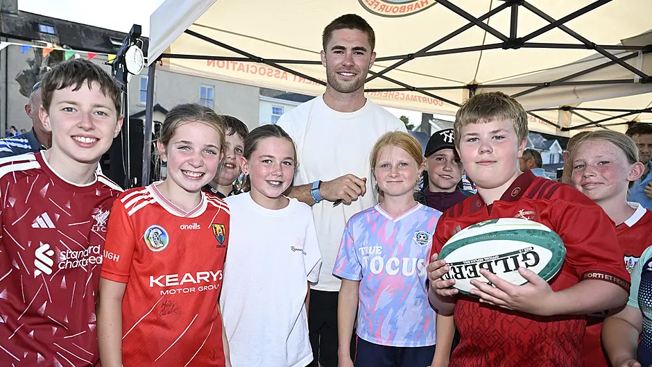Irish Rugby International fly-half Jack Crowley, who officially opened the Courtmacsherry Harbour Festival in Courtmacsherry pictured with some young fans. Photo: Martin Walsh.