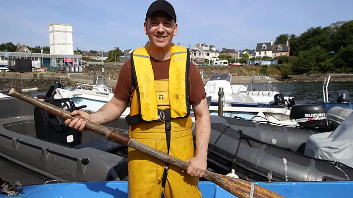 Fisherman Colin Sheehan pictured at Schull Harbour, with a traditional wooden oar before another day at sea. Photo by Carlos Benlayo