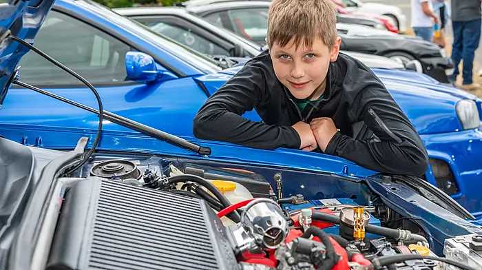 Liam Kubella from Bandon checking out the engine on a Subaru the Pike Festival’s charity tractor, truck, car and bike run last Sunday which was held in aid of West Cork Rapid Response and other local charities.  (Photo: Andy Gibson)
