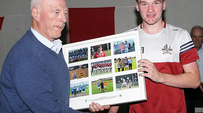 DJ Daly, president of Kilmeen/Kilbree GAA Club, makes a presentation to Howard O'Donovan in recognition of his achievements with the Cork minor hurling team. (Photo: Paddy Feen)