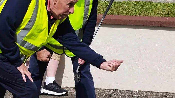 Paul O’Driscoll from Horizons COPE Clonakilty throwing the winning road bowl of the men’s Novice A competition at the Unlimited Road Bowling Finals in Bantry, being supported by James O’Driscoll from Bol Cummann.