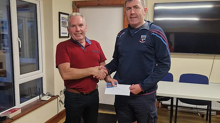 Ibane Gaels treasurer Brendan Coleman (right) presenting Ger O'Sullivan, Ardmore, Timoleague with his €500 prize, for having the correct time on the scratch card for the first goal scored in Sunday's match between Argideen Rangers and Barryroe.
