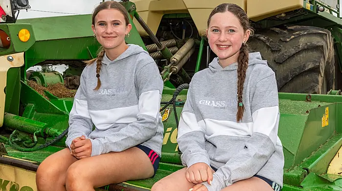 Ahiohill, West Cork, Ireland. 2nd Aug, 2026. Ahiohill Vintage Club held its annual Vintage Harvest Day today. Thousands of people attended, many from different parts of the country, to see farming demonstrations, farm machinery and much more. Andrea Deane and Katelyn Collins from Kilbrittain with a Krone Big M 500 mower. Picture: Andy Gibson.