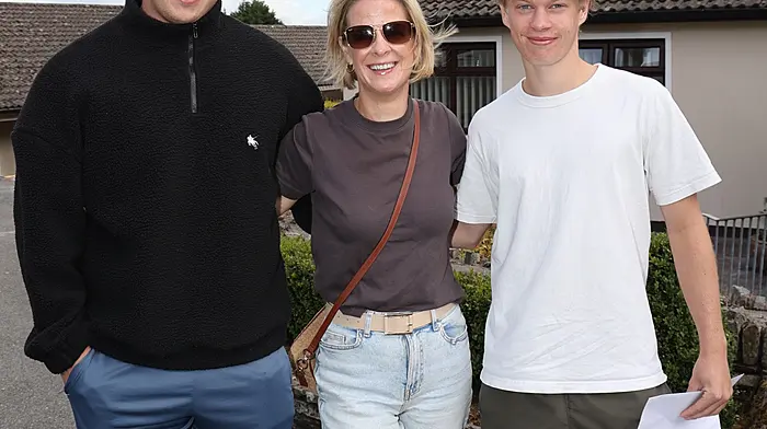 Zach Piper and Theo Belltoise with their religion teacher Ms Crowley at Bandon Grammar School when they collected their Leaving Cert results. (Photo: Donie Hurley)
